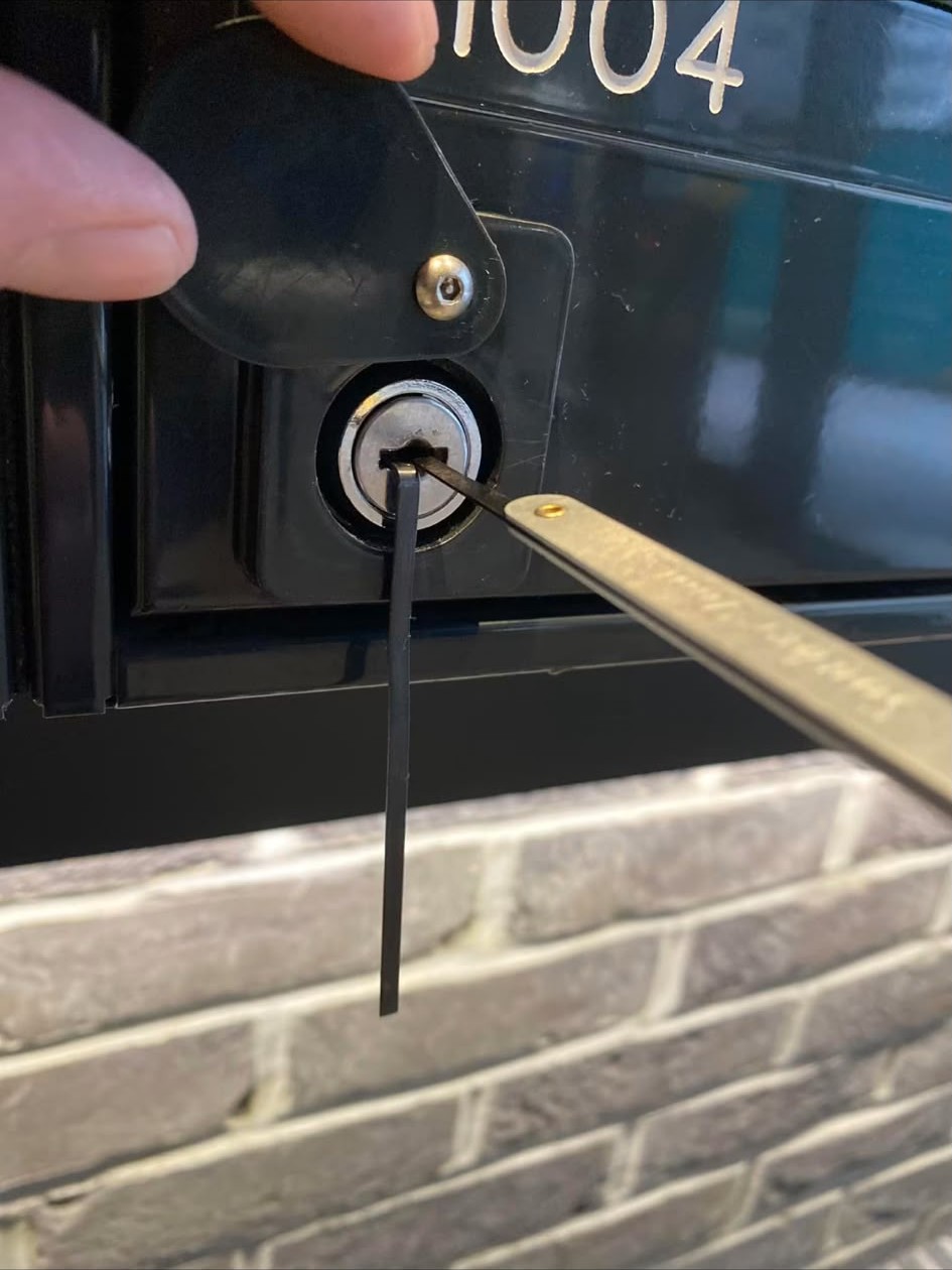 Locksmith picking a lock during non-destructive gaining entry work in London