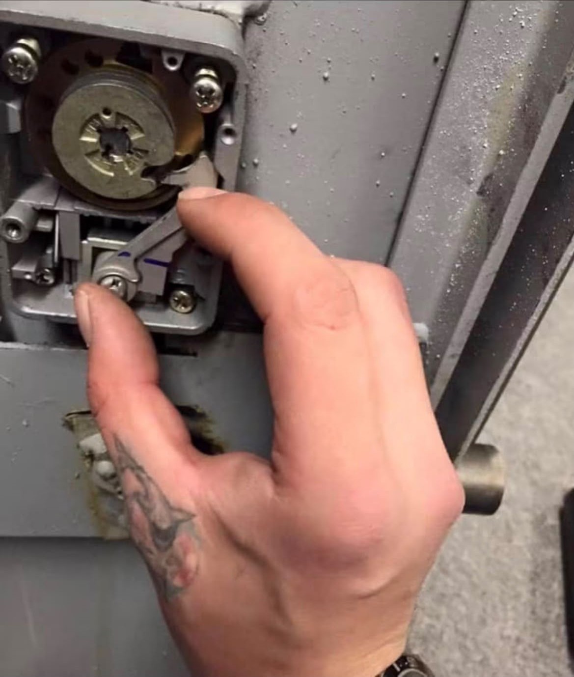Safe engineer manipulating the internal wheel pack of a mechanical safe lock