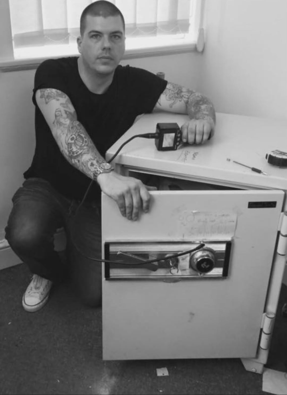 Safe engineer using a borescope to inspect a safe lock during a safe opening in London