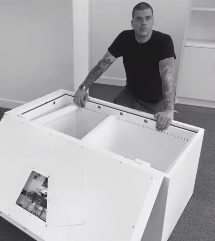 Locksmith working behind an opened safe during a safe opening job in London