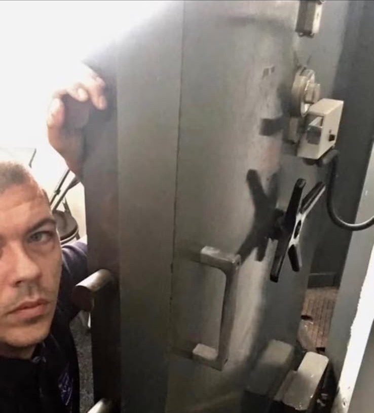 Locksmith opening a vault-style safe during a safe opening job in London