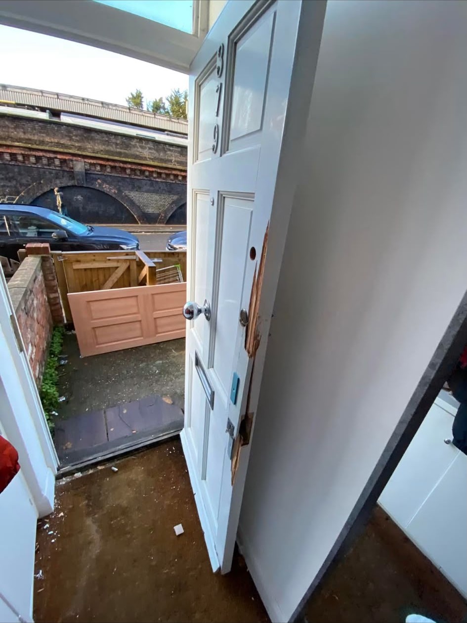 Splintered timber door frame after a forced-entry burglary in London before repair